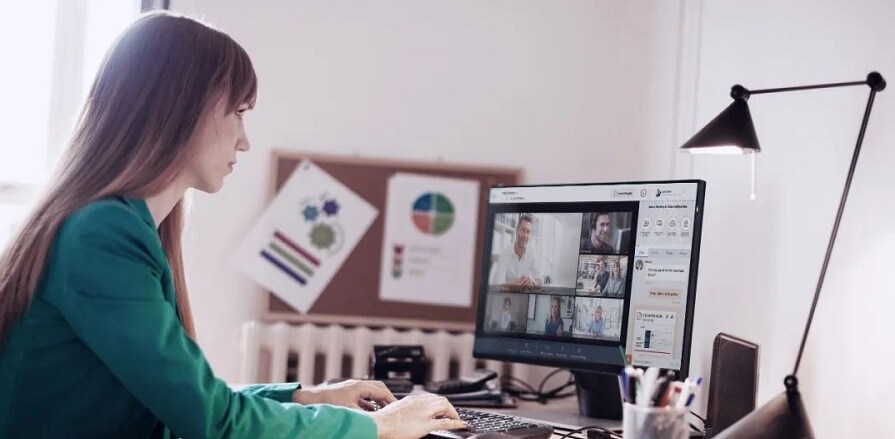 Woman in a green top working on a computer