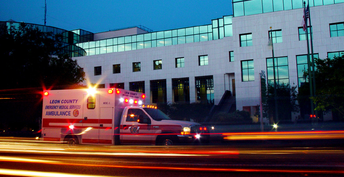 Leon County ambulance driving by a building