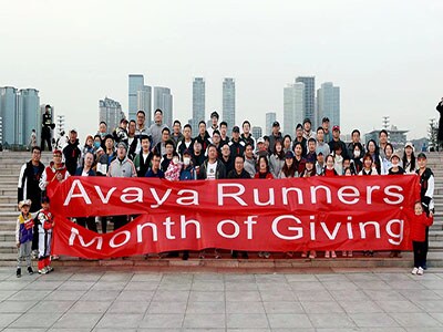 Avayans holding up Month of Giving sign