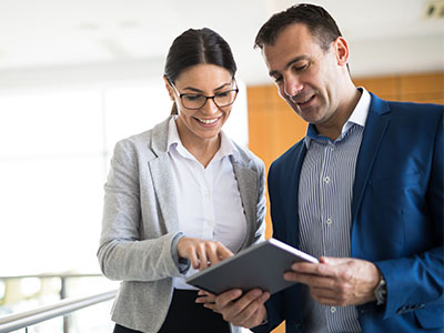 Two business people discussing business strategy using digital tablet