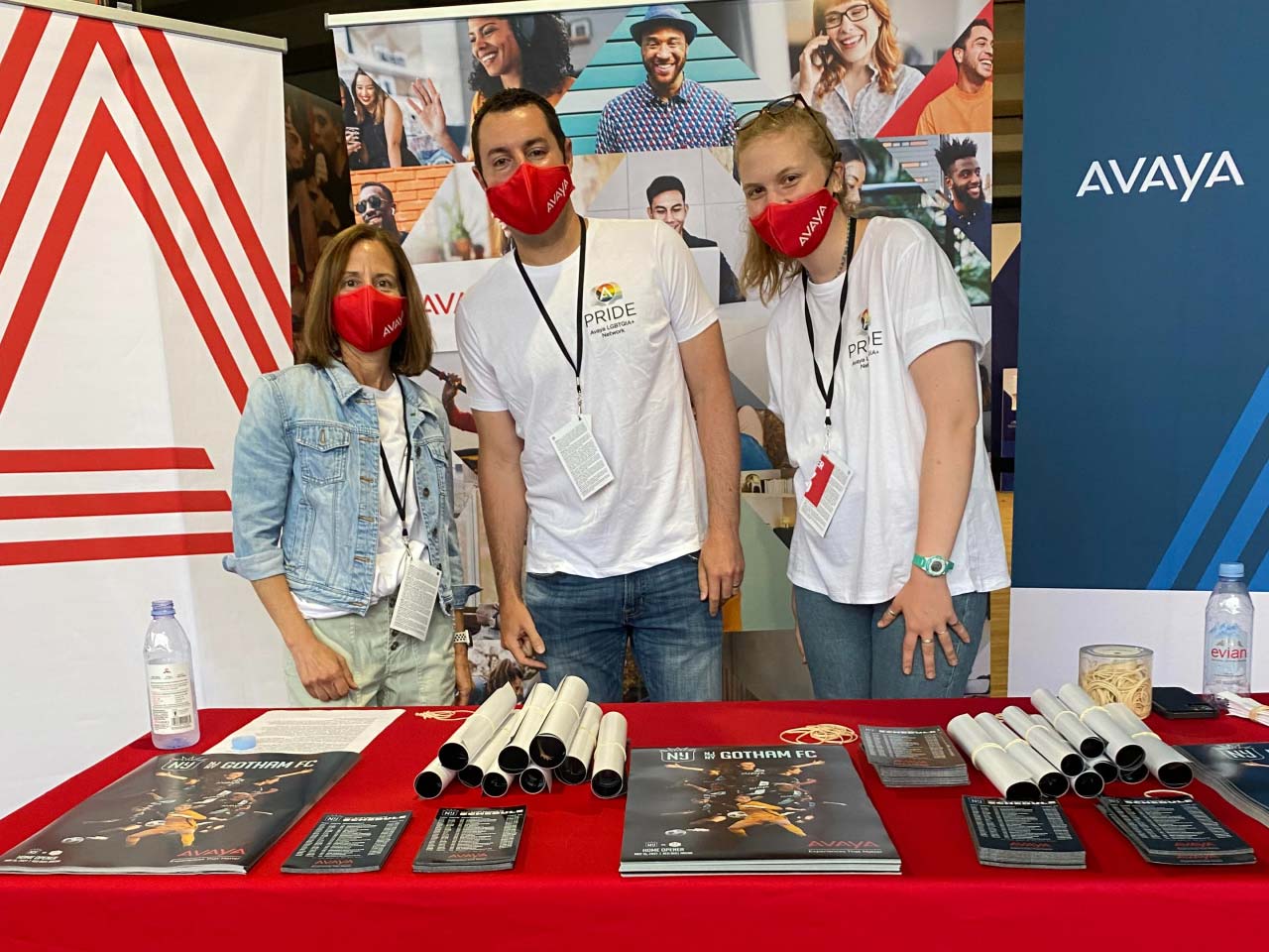 Avaya Employees standing at a booth with Avaya masks on