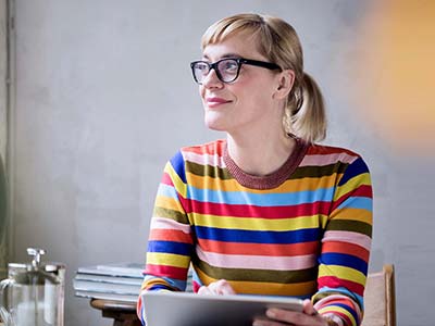 Woman with glasses using tablet