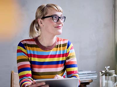 Woman with glasses using tablet