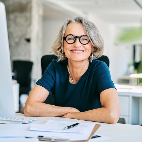 Smiling businesswoman at desk in office