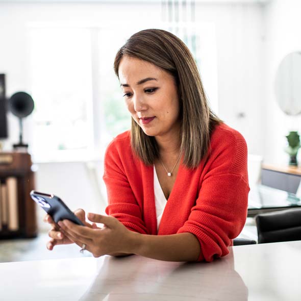 Woman using mobile device at home