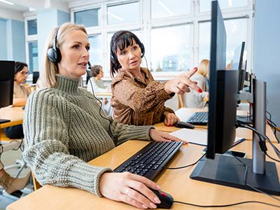 Female manager talking with call agent over computer 