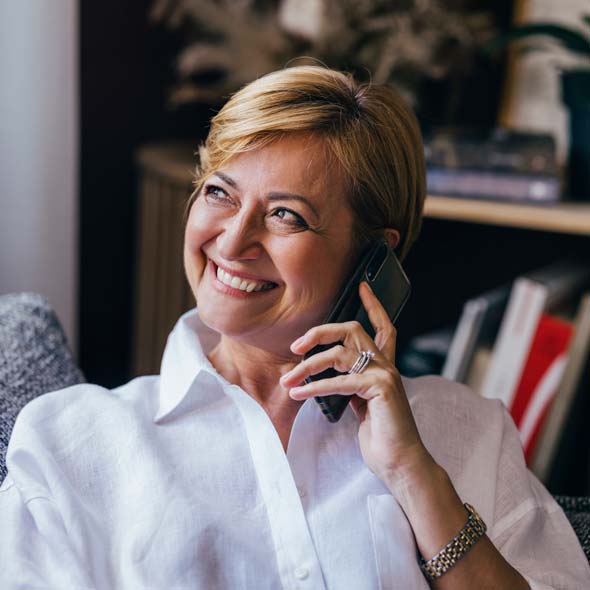 A happy senior businesswoman talking to somebody on the phone