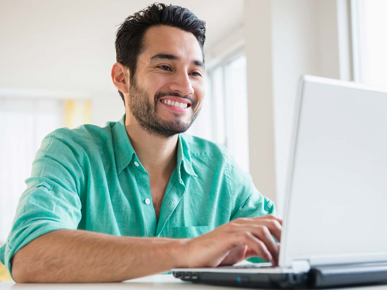  Smiling man on laptop