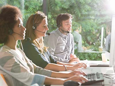 Call center agents answering calls in office