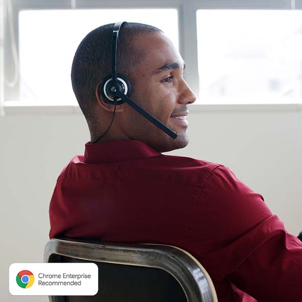 Businessman sitting in office wearing headset