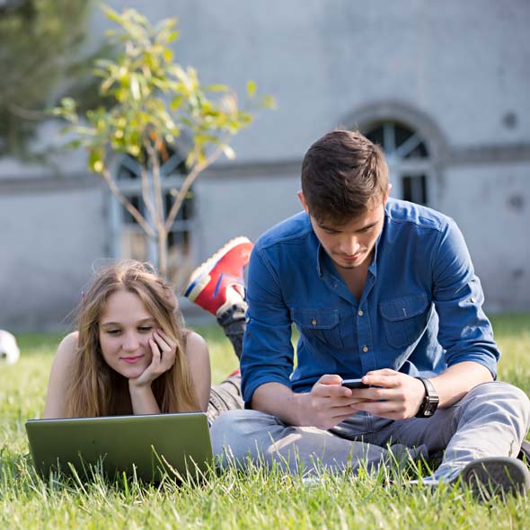 Students at the school doing schoolwork on the quad